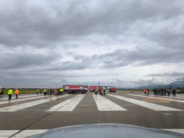 Airport tarmac scene shows wet conditions after recent rain