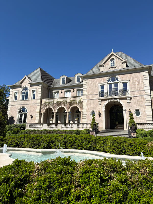 Grand mansion estate photographed in Potomac under clear skies