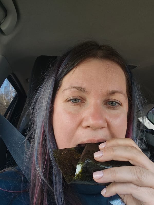 Woman photographs herself eating rice ball in car, Russia