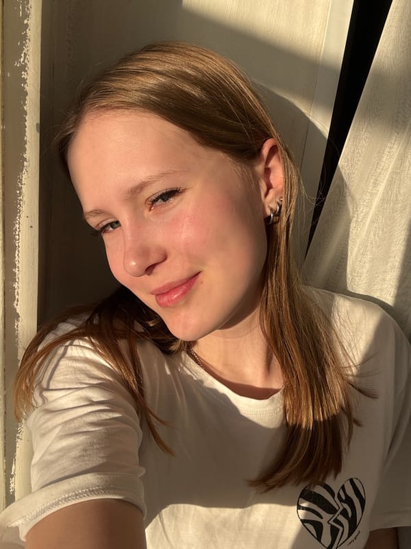 Woman observed resting indoors near window in Chaikovsky