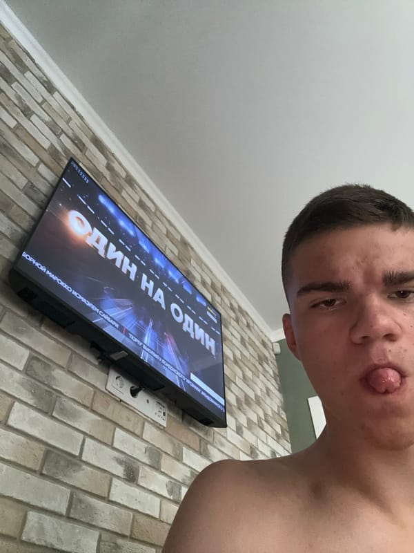 Selfie session in front of a soccer match on TV