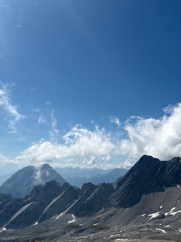 Alpine viewpoint busy with visitors on a clear summer morning