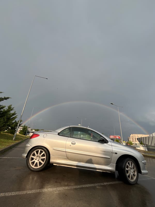Double rainbow over a wet parking lot in Shumen, Bulgaria