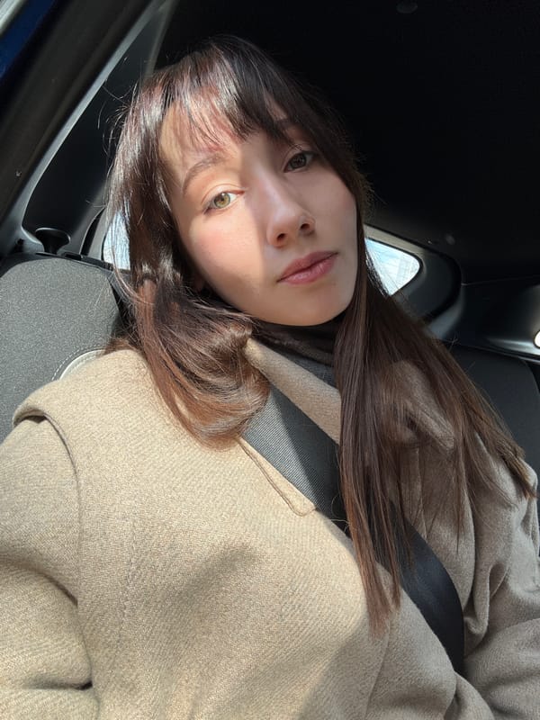 Woman in beige coat observed in car driver's seat, Kazan