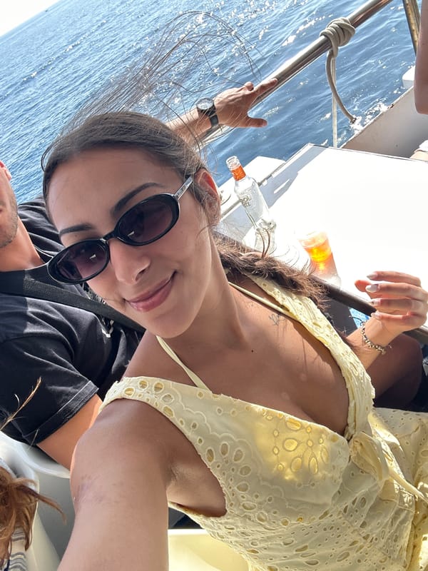 Out on the water, cruising past a rugged coastal shoreline