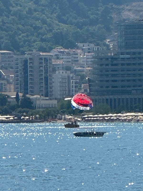 Parasailing activity captured off Budva coast on sunny afternoon