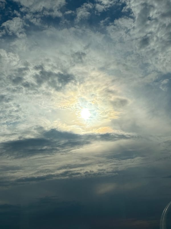 Dramatic afternoon sky with sun breaking through varied clouds