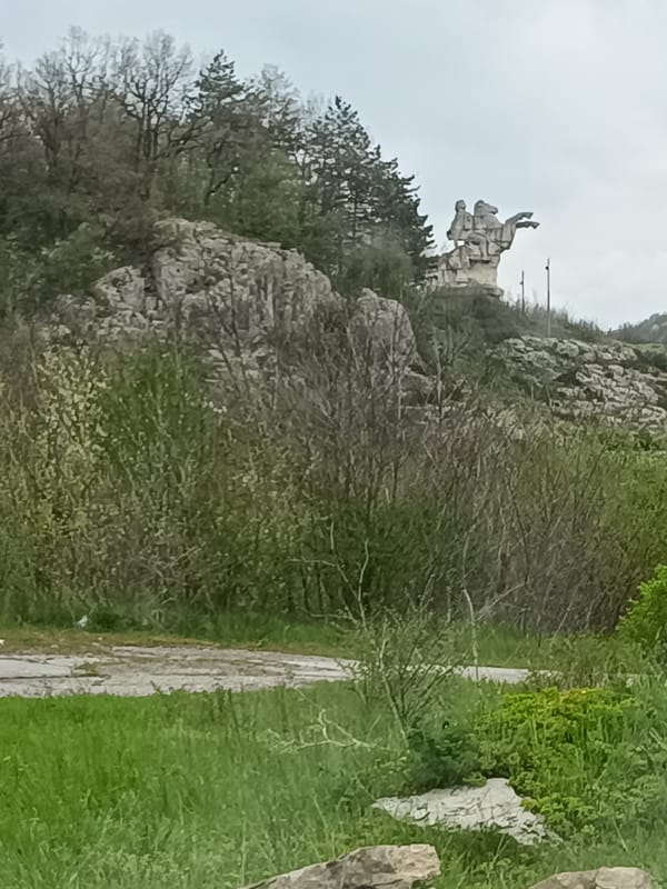 Tourist documents waterfall and stone monument in Paidushko, Bulgaria