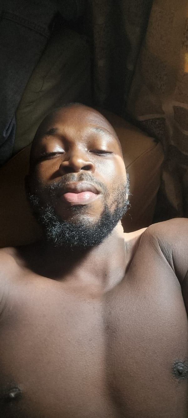 Man rests in sunlight on bed or couch