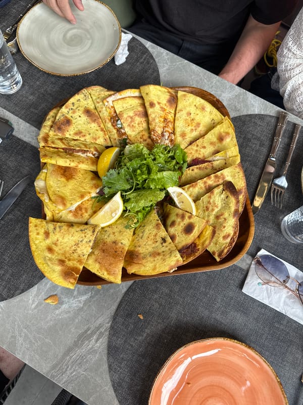 Wooden platter of folded flatbreads at a Yerevan restaurant