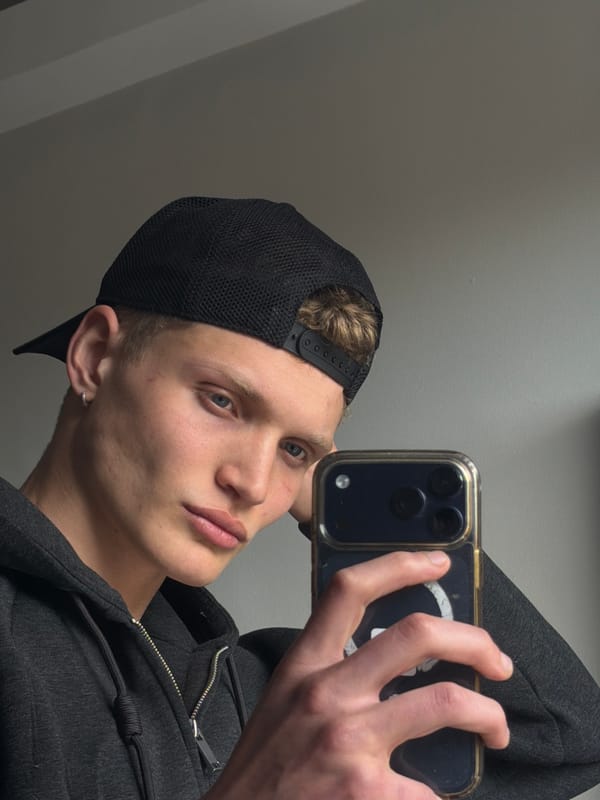 Young man takes selfies indoors in London residential setting