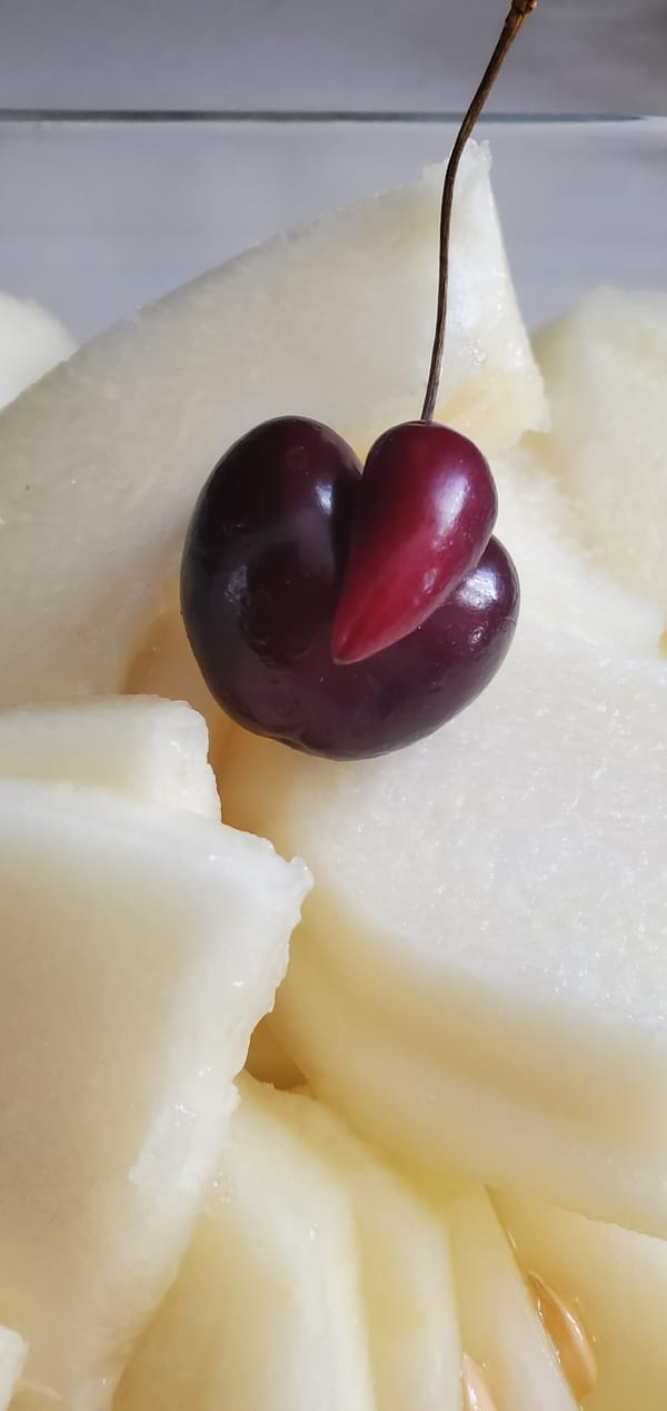 Sliced melon and a double cherry, close up in Greece