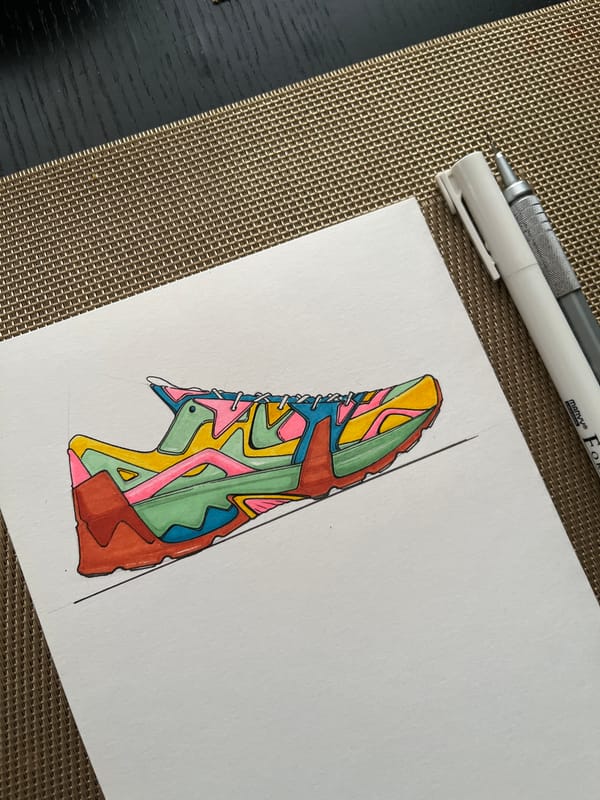 Colorful sneaker drawing captured with pens on wooden surface