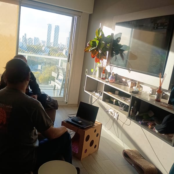 Person works on laptop at dice-patterned table indoors