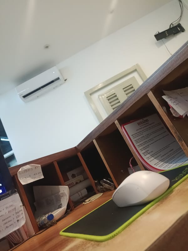 Cluttered workspace with computer mouse documented by witness