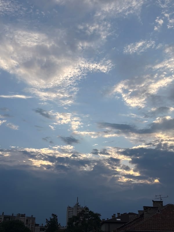 Urban rooftops and cloudy sky, mid-afternoon city overview