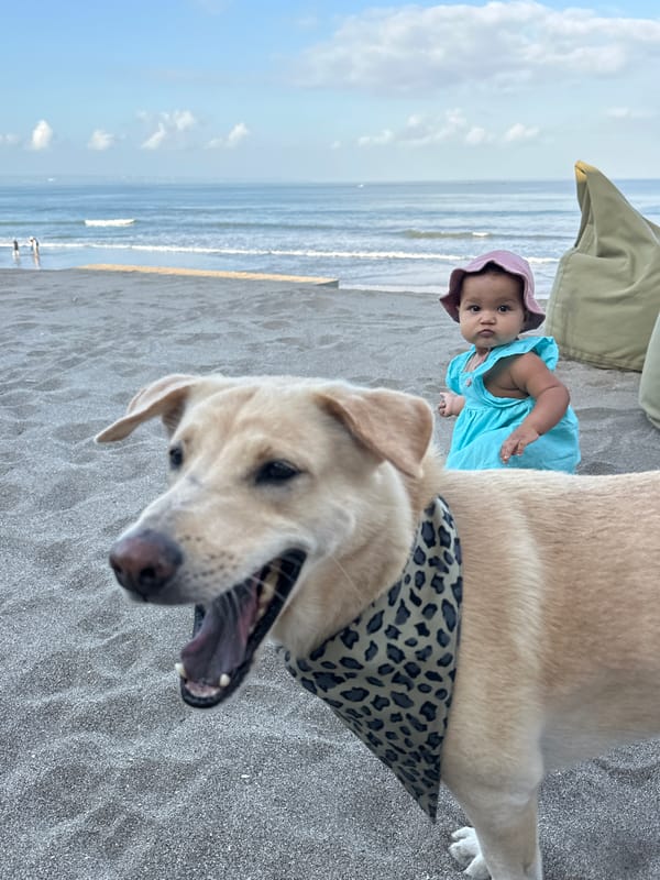 Family beach time on North Kuta's dark sand shores