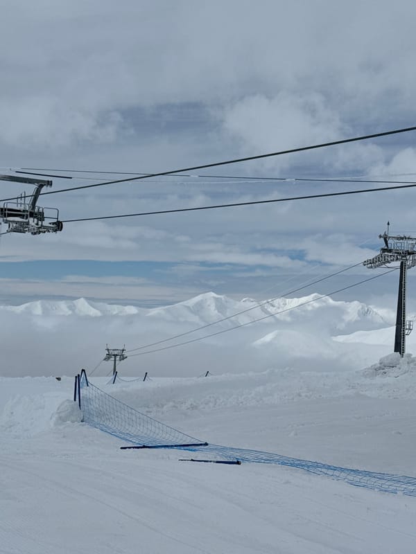 Gondola lifts operate at Gudauri ski resort during snowy morning