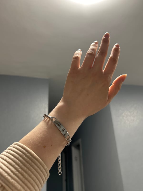 Person displays hand jewelry and nail art in Saint Petersburg