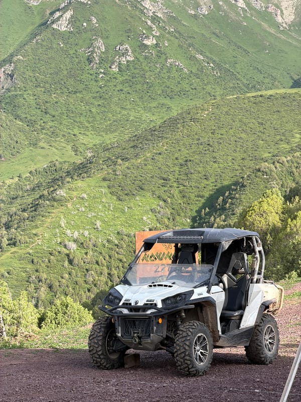 Alpine gathering in Kashka Suu: tents, ATVs, and mountain scenery