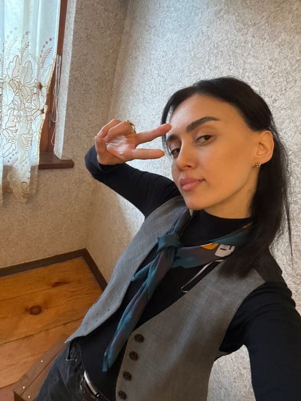 Woman makes peace sign gesture in Georgian living room