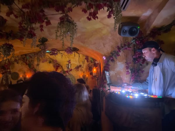 Candlelit venue with DJ and crowd captured in Paris