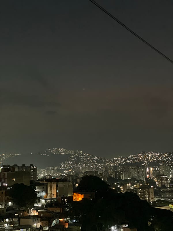 Aerial night view captures divided urban landscape in Caracas