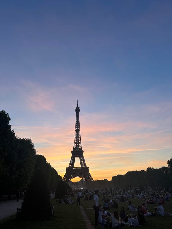 Eiffel Tower at sunset, crowds on the Champ de Mars