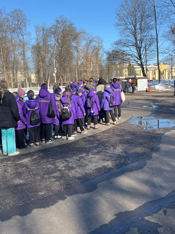 Schoolchildren in purple jackets line up on Nizhny Novgorod street