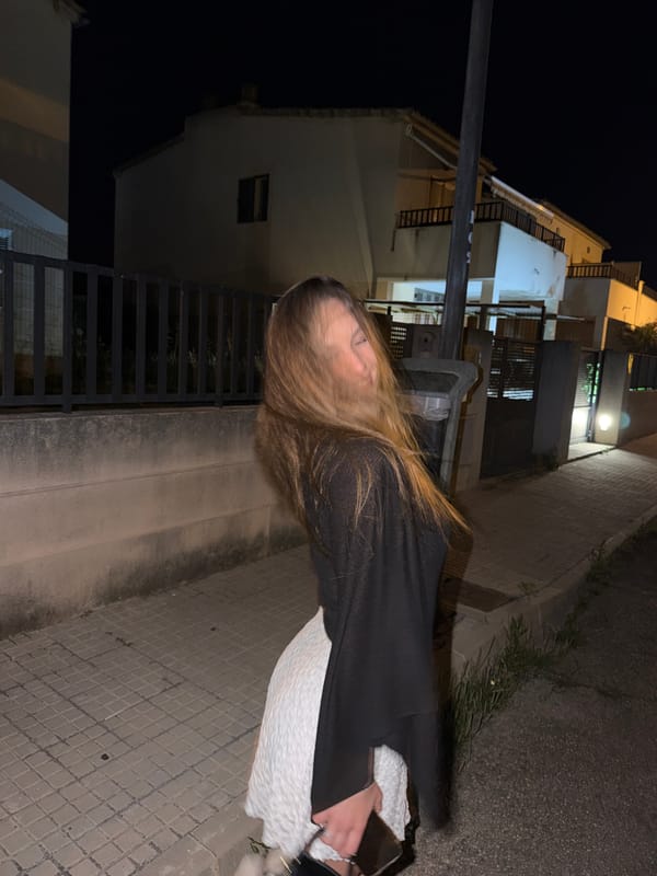 Woman in white dress photographed on Alcúdia streets at night