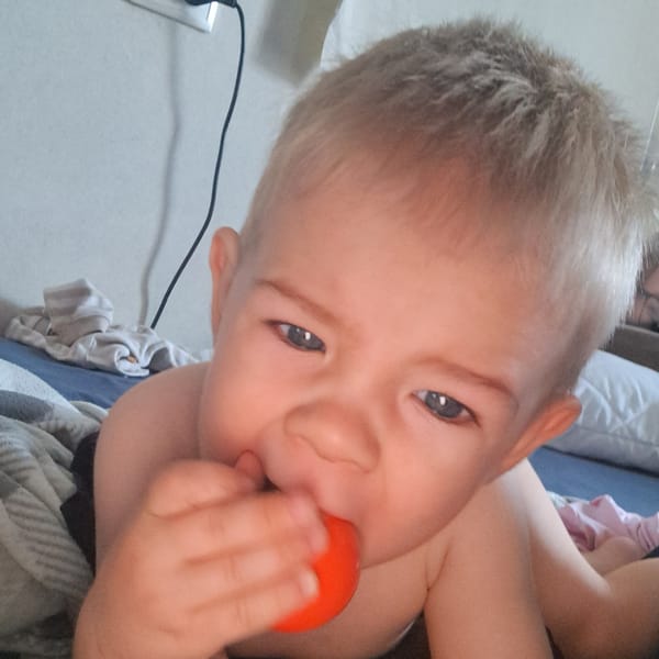Baby playtime on a bed in Krasnoyarsk