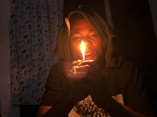 Late-night lighter selfies in a dim room, Ihiagwa
