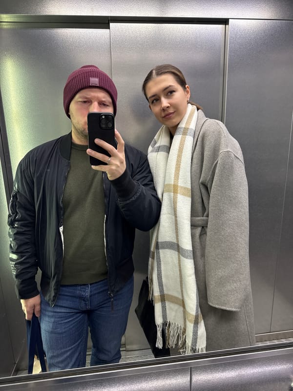 Two people caught in elevator reflection in Krasnoyarsk