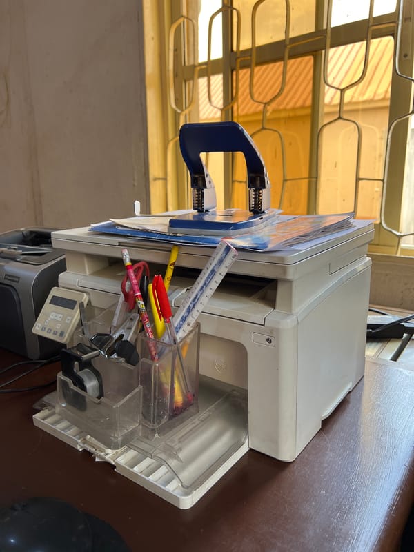 Office worker conducts business calculations at desk in Jos