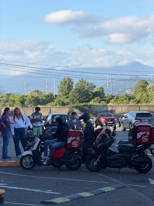 Afternoon activity around a Sirius, Russia parking lot and walkways