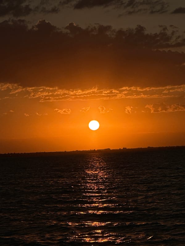 Vivid orange sunset over a Kokshetau waterway