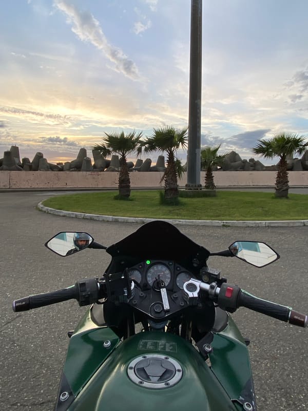 Motorcyclist on green Kawasaki Ninja parked in Sochi