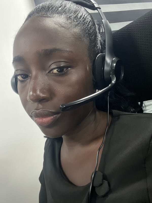 Woman photographed wearing headset in Karum office setting