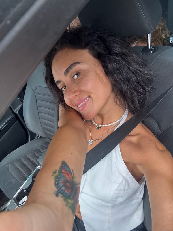 Quick in-car selfies in Tbilisi, pearl necklace and butterfly tattoo