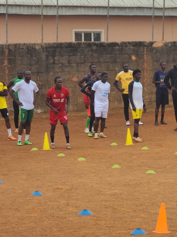 Soccer training session observed on dirt field