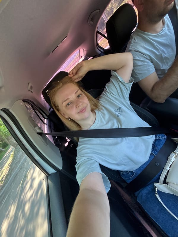 Woman takes selfie in backseat during car ride in Yaroslavl