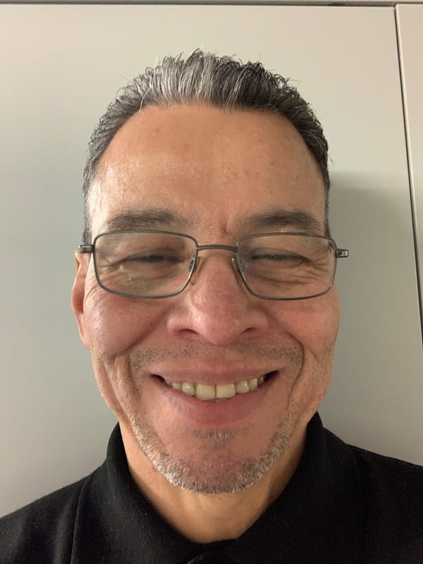 London resident photographed smiling with eyes closed indoors