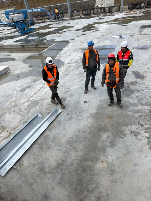 Construction workers active at steel beam site in Stróża, Poland