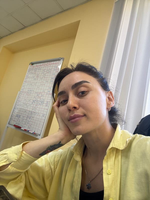 Woman with butterfly tattoo rests indoors in Tbilisi