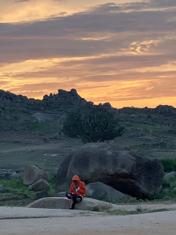 Pickup football and crowd energy on the rocky outskirts of Jos