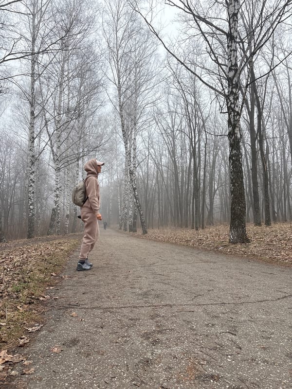 Morning walker navigates foggy park path in Ulyanovsk