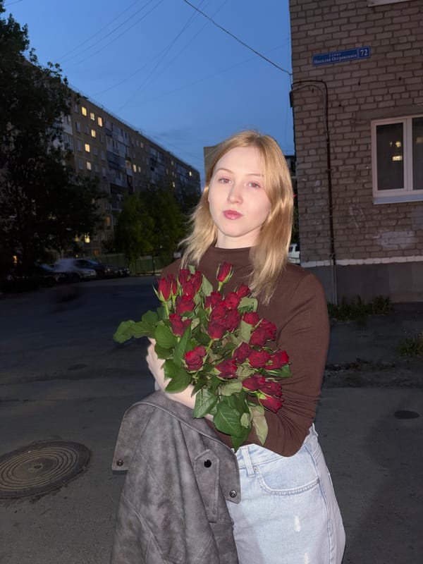 Woman with roses and blue Subaru documented in Perm