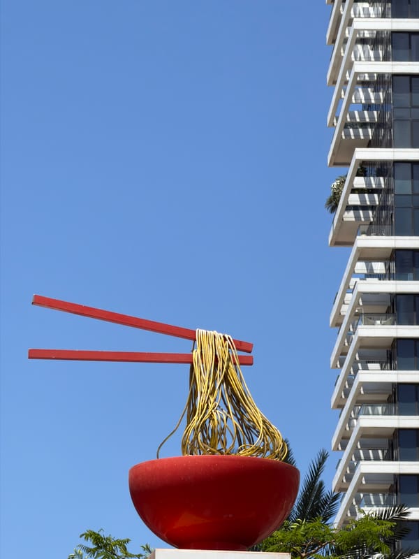 Morning scenes captured around red sculpture and skateboarder in Tel Aviv