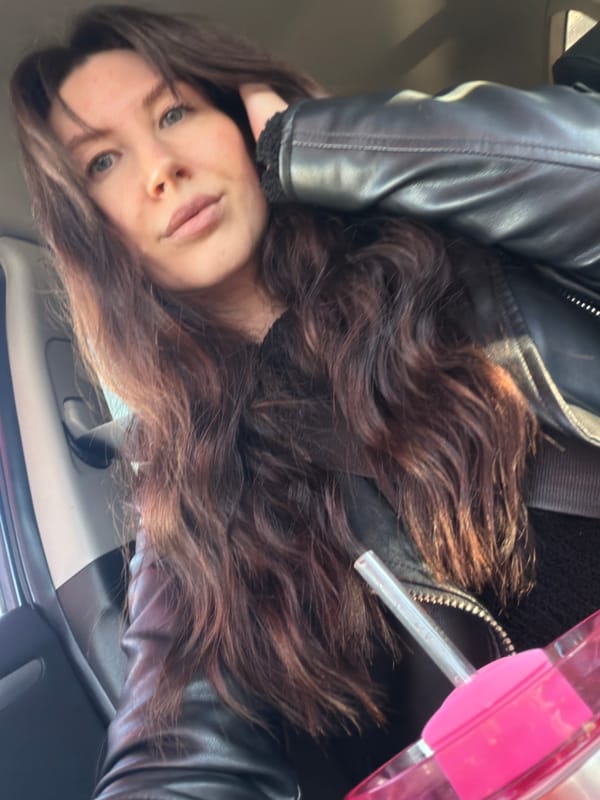 Woman enjoys drink in car in Perm, Russia