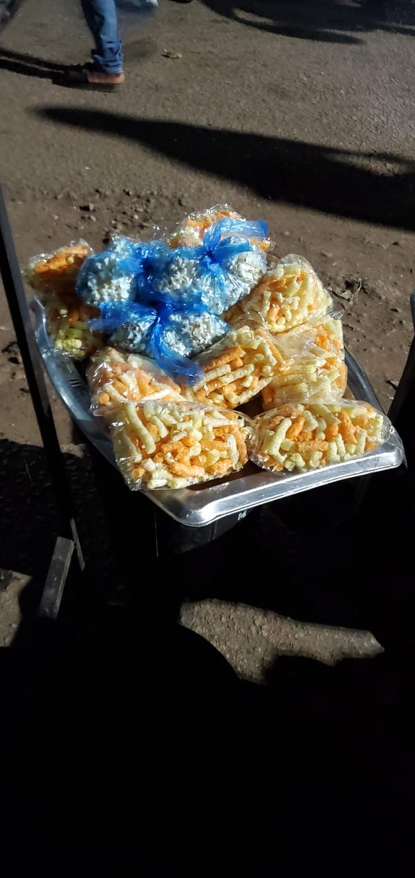 Night street food vendors serve snacks and fruit